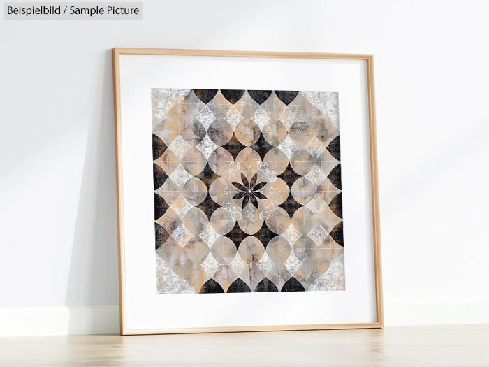 Framed geometric abstract art on white wall, featuring circular and star shapes in neutral colors.