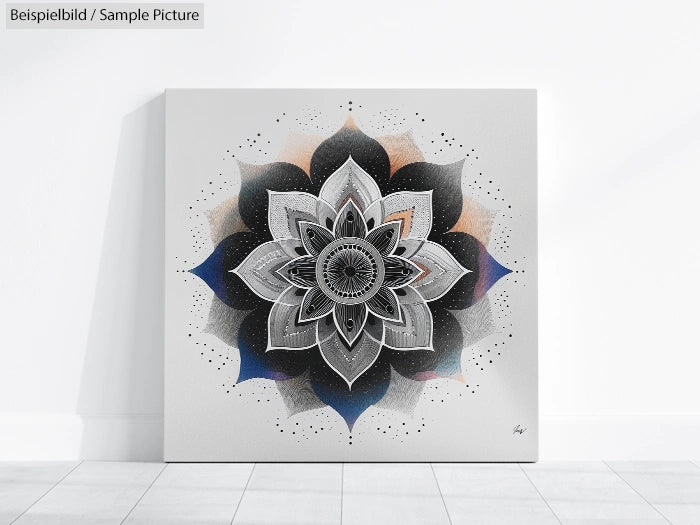 Monochrome mandala artwork on white canvas displayed on a light-colored floor.