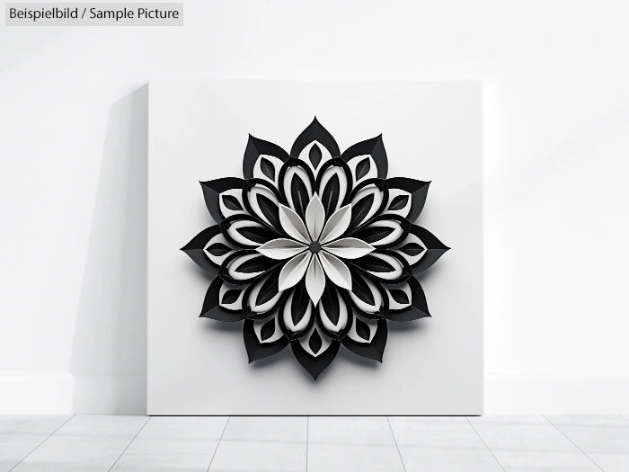 3D black and white paper cut-out mandala on white canvas framed on a wall.