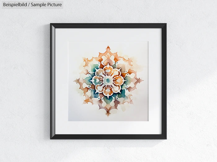 Framed artwork with intricate mandala design in beige, teal, and orange hues against a white wall.