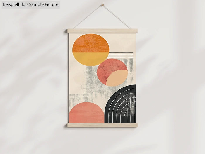 Abstract wall art with geometric shapes in orange, red, and black, hanging on a white wall.