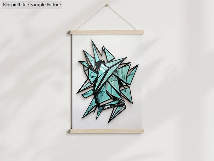 Geometric abstract teal and black artwork in a light wooden frame hung on a white wall.