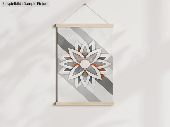 Wall hanging with geometric flower design in gray and orange tones, framed by light wooden bars.