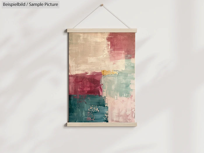 Abstract painting with blocks of red, teal, and beige, hanging in a simple wooden frame against a white wall.