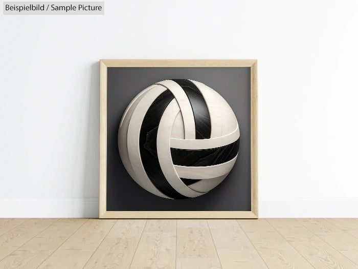 Framed artwork of a black and white spherical 3D pattern on a gray background, leaning against a white wall.