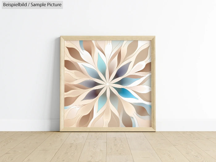 Framed abstract artwork with beige, blue, and white petals forming a symmetrical pattern, leaning against a white wall.