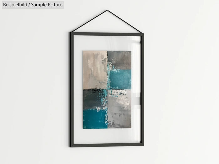 Abstract painting with teal, gray, and beige squares in a black frame, hanging on a white wall.