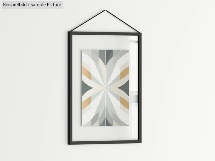 Framed abstract geometric art with symmetrical pattern in neutral tones, hanging on a white wall.