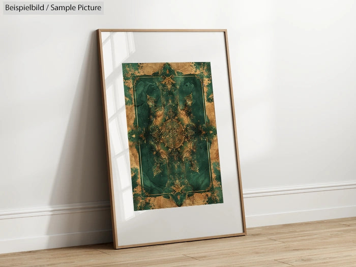 Framed abstract artwork with green and beige geometric pattern, leaning against a white wall on a wooden floor.