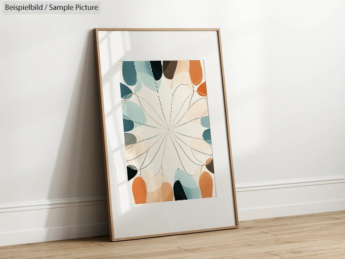 Framed abstract painting with pastel tones leaning against a white wall on a wooden floor.