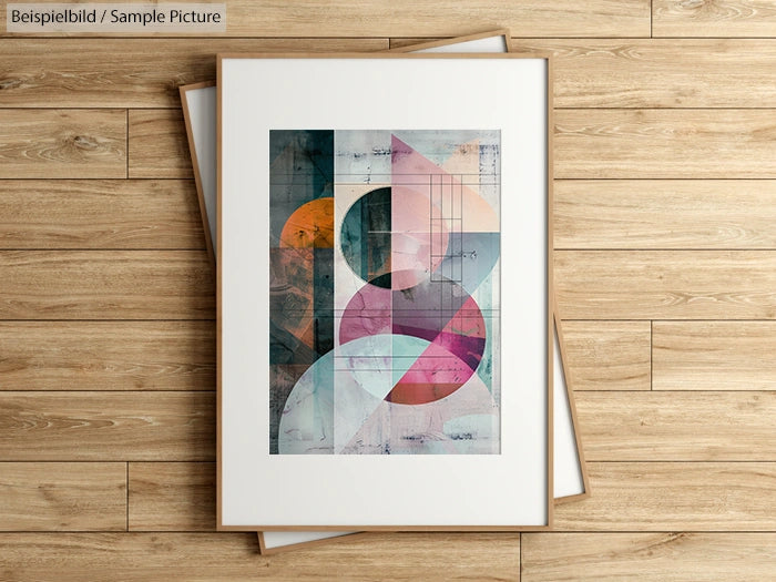 Abstract geometric painting with overlapping circles and shapes in pastel colors, framed and placed on wooden floor.