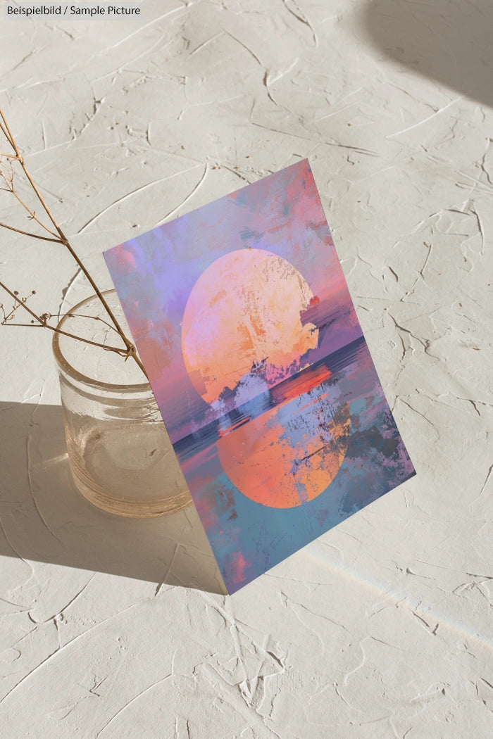 Colorful abstract art card on textured surface, featuring a large sun-like circle with vibrant hues.