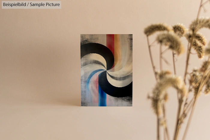 Abstract painting with swirling black, blue, and red lines on a neutral background, dried flowers in foreground.