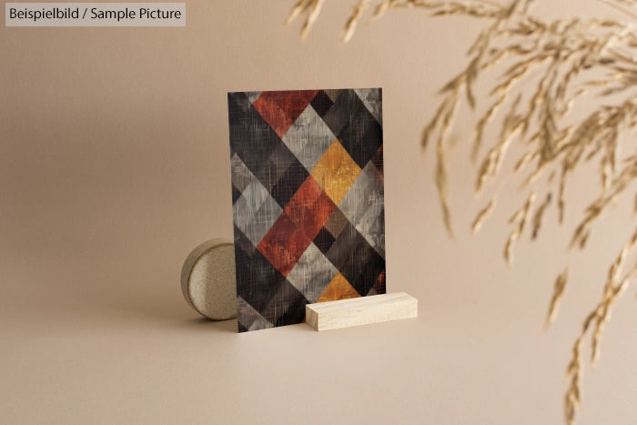 Geometric patterned photo card on display with natural decor on a beige backdrop.