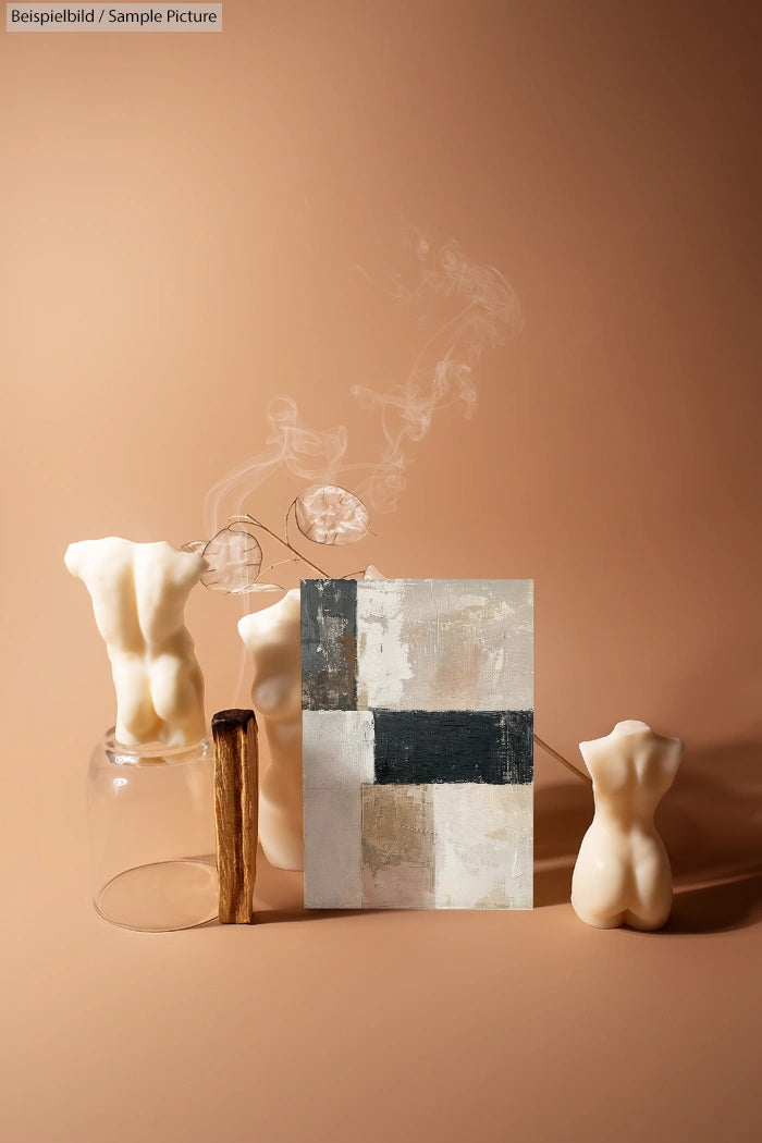 Abstract painting with muted tones, surrounded by artistic candles shaped like human torsos on a beige background.