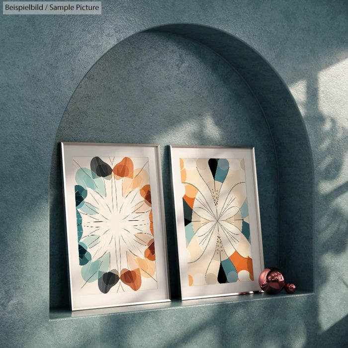 Two abstract art prints with geometric patterns in a sunny archway niche, featuring earthy tones.