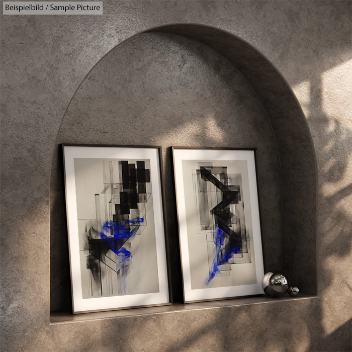 Two abstract paintings with black shapes and blue accents, displayed on a shelf in an arched niche with shadow effects.