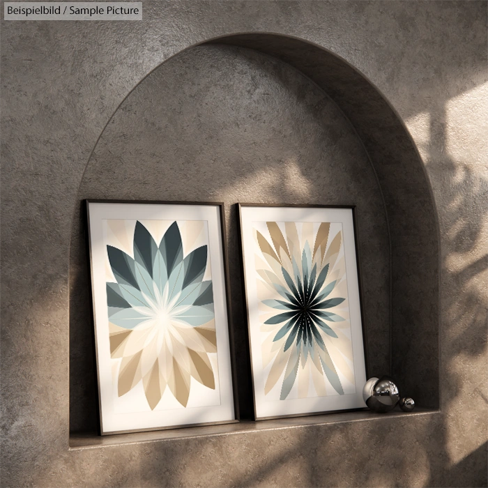 Two abstract flower art pieces in matching frames on a curved shelf with a marble background and metal balls.