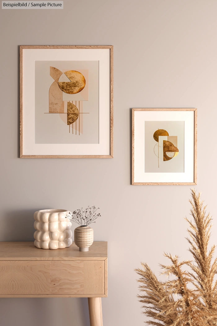 Modern interior with abstract art on a beige wall, wooden table, and decorative vases, featuring pampas grass.