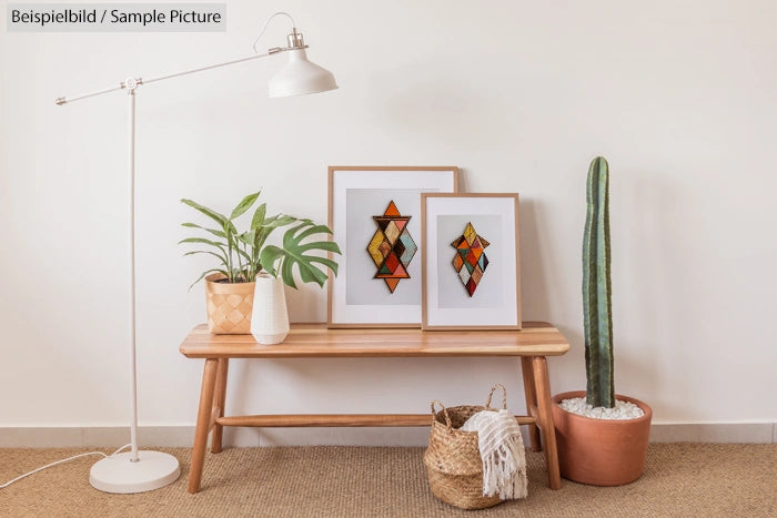 Minimalist room with wooden bench, framed geometric art, plants, and floor lamp.