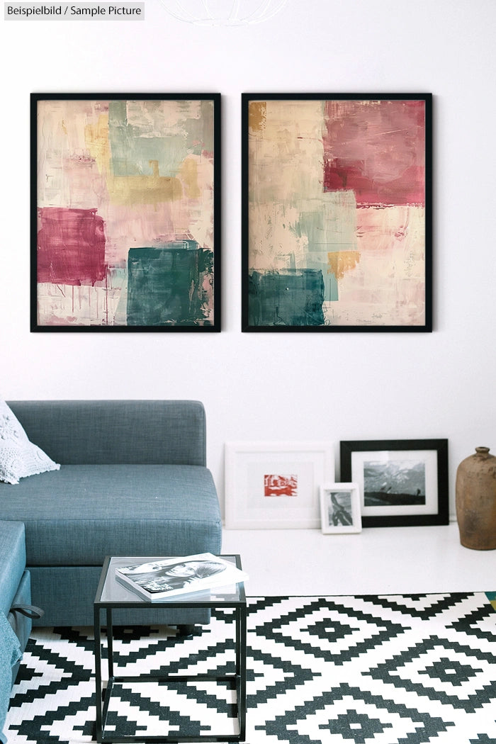 Modern living room with abstract paintings above a grey sofa, geometric black and white rug, and a glass coffee table.