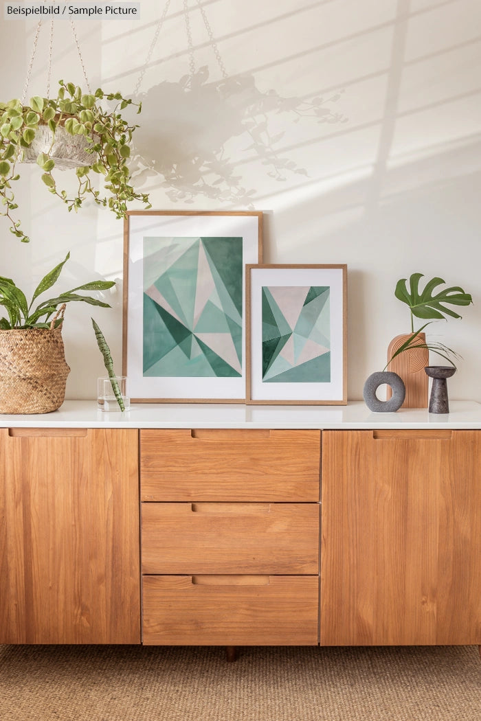 Mid-century sideboard with geometric art, plants, and decor items.