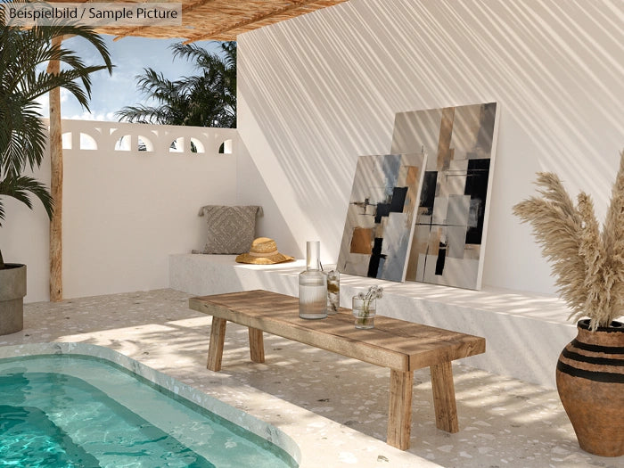 Minimalist patio with wooden bench, abstract art, and white wall, beside a turquoise pool and potted plants under sunlight.