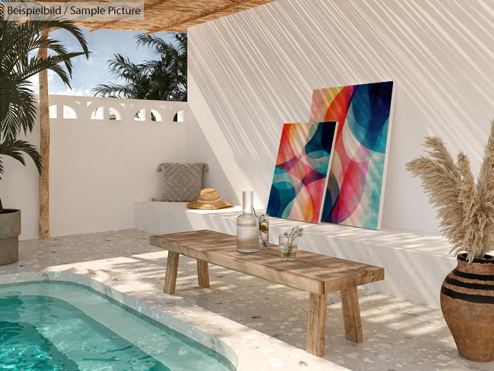 Outdoor terrace with abstract colorful paintings, wooden bench, and pool, under palm trees and a shaded canopy.