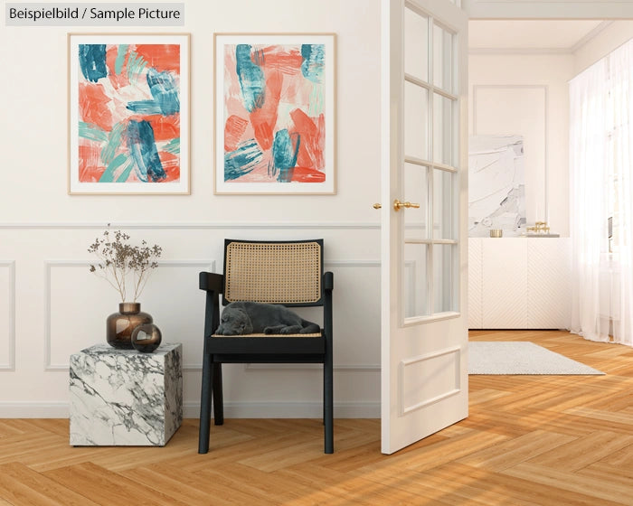 A modern living room with abstract art, a black chair, marble side table, and hardwood floors.