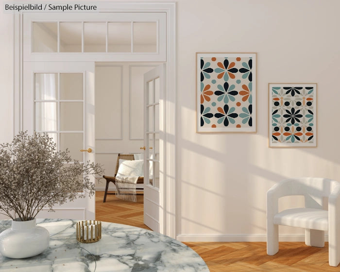 Elegant interior with geometric art, marble table, white chair, and hardwood floors. Light filters through glass doors.