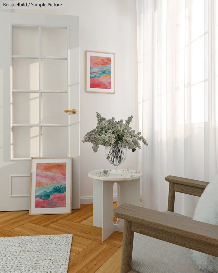 Bright room with wooden floor, abstract art, white table with flowers, and soft natural light through sheer curtains.