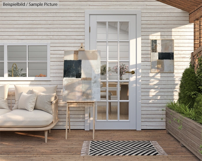 Cozy patio with abstract art, white cushions, and wooden decor, facing a glass door leading indoors.