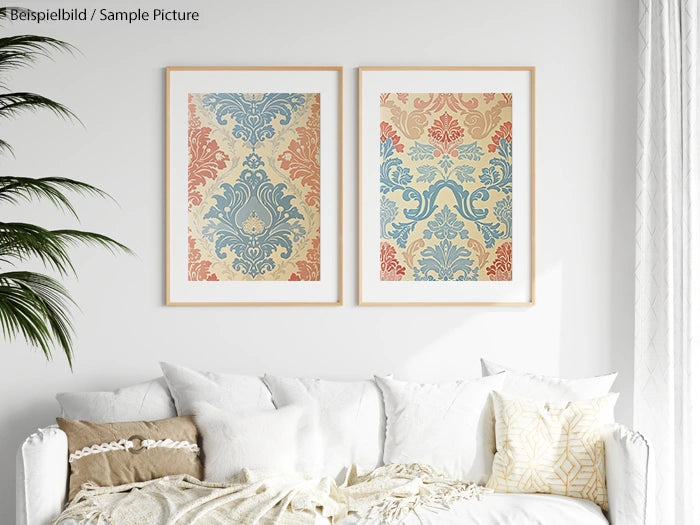 Living room with two ornate framed prints above a white sofa, accented with beige and patterned pillows.