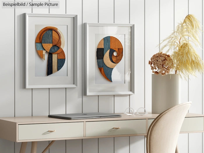 Modern desk with laptop, beige chair, and framed abstract wall art on a light wood panel background.