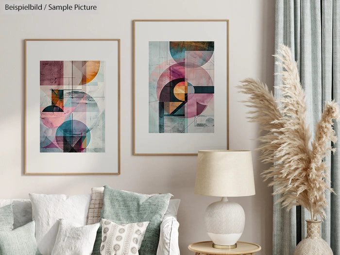 Modern living room with abstract art, beige sofa, textured pillows, and a white table lamp beside tall pampas grass.