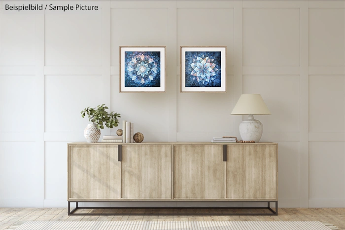 Modern living room with wood sideboard, two geometric art pieces, and a lamp.