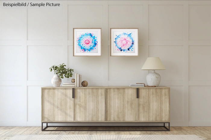 Modern living room with wood sideboard, two abstract paintings, and decorative items.