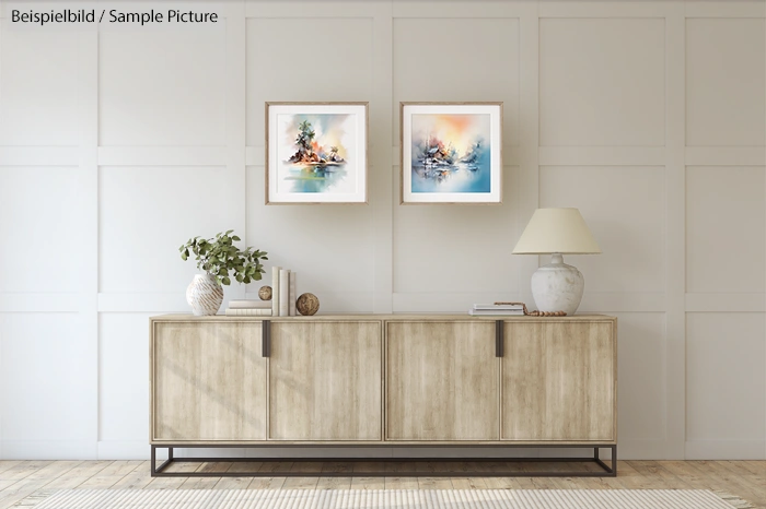 Modern living room with light wood sideboard, two abstract paintings, a decorative plant, books, and lamp on top.