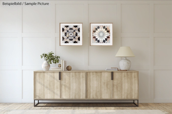 Minimal living room with a wooden sideboard, decorative items, and two framed artworks on a paneled wall.