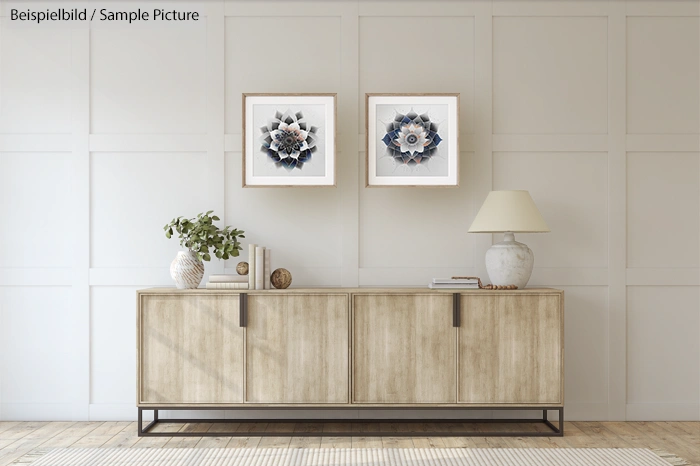 Modern living room with wooden sideboard, decorative items, lamp, and two framed abstract artworks on the wall.