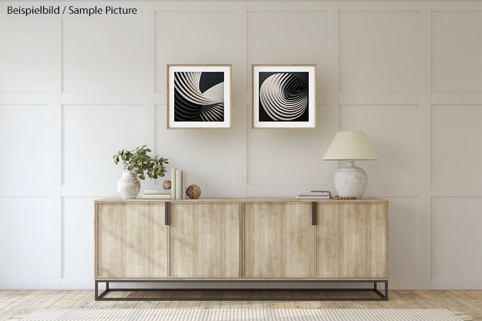 Modern living room with wooden sideboard, abstract wall art, and white table lamp.