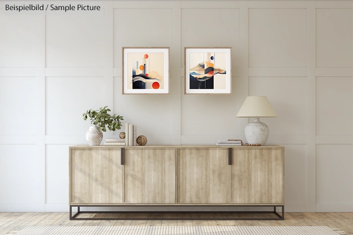 Modern living room with wooden cabinet, two abstract paintings, lamp, and potted plant against a paneled wall.