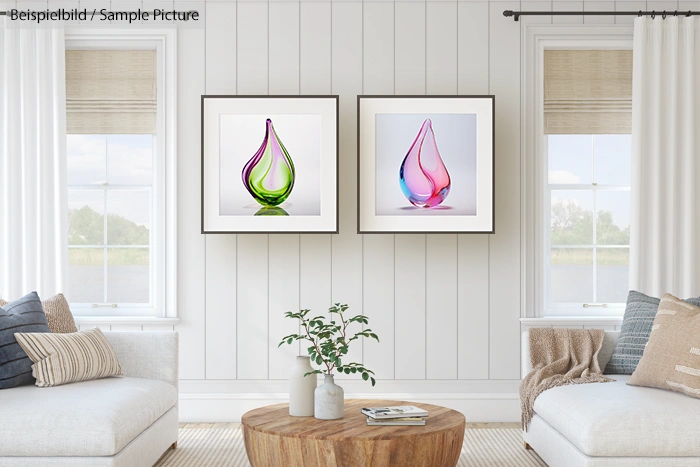 Living room with white walls, two colored glass art pieces on wall, natural light, and a wooden coffee table.