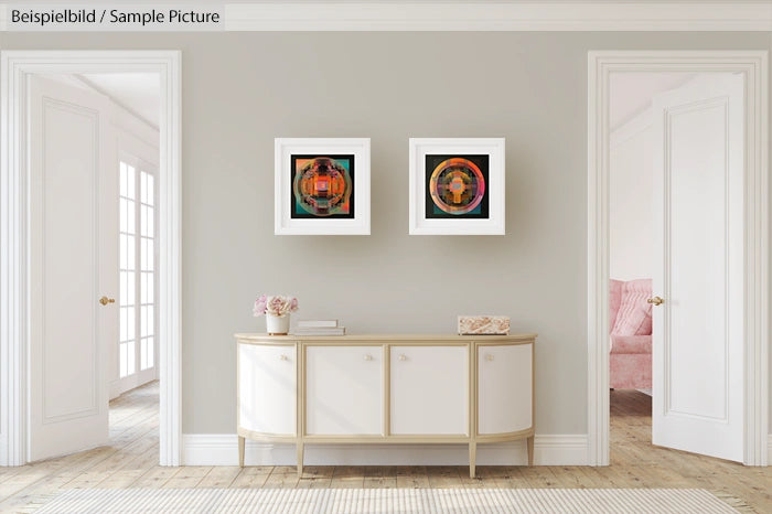 Elegant living room with two abstract paintings, white console table, and pink flowers. Neutral walls with white trim.