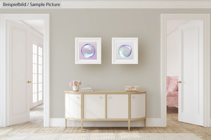 Elegant hallway with sideboard, pink flowers, two abstract art pieces, and doorways on either side.