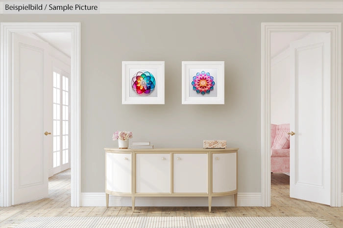 Modern living room with two colorful geometric art pieces, white sideboard, and neutral walls.