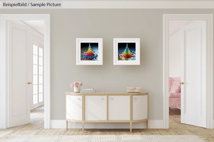 Elegant room with cream sideboard, two colorful art prints on wall, and doorway revealing a pink chair in the next room.