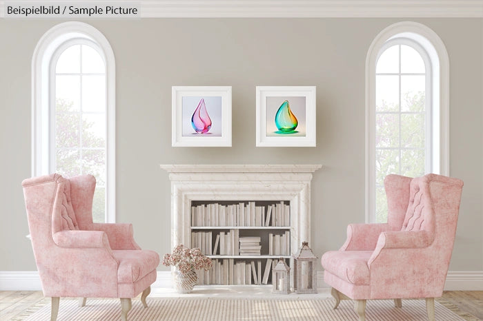 Elegant living room with pink chairs, a white fireplace, books, and framed abstract art on a light gray wall.