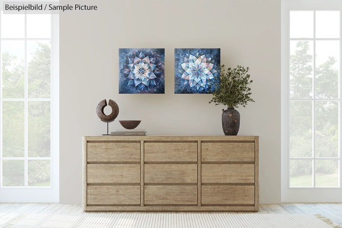 Minimalist room with light wood dresser, abstract blue art, vase with greenery, and modern decor on top.