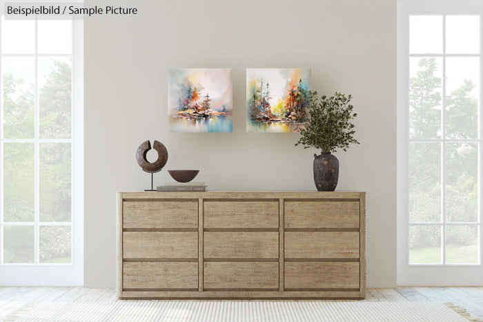 Modern living room with light wood dresser, abstract paintings, and decorative plant on top of the dresser.